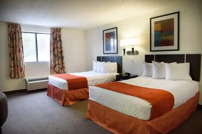 a hotel room with two beds and a window at Americas Best Value Inn New Paltz in New Paltz
