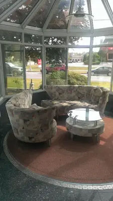 a living room with two couches and a coffee table at Branford Motel in Branford