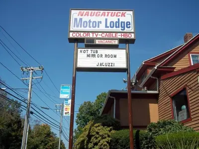 a sign for a motor lodge in front of a house at Naugatuck Motor Lodge in Naugatuck