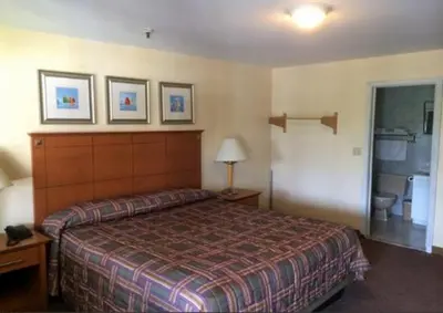 a hotel room with a bed and a bathroom at Naugatuck Motor Lodge in Naugatuck