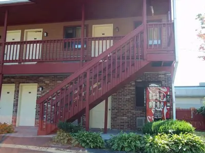 a building with a red staircase on the side of it at Naugatuck Motor Lodge in Naugatuck