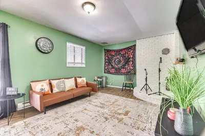 a living room with green walls and a couch at Game Room and Pool Access Pocono Paradise Haven in Tobyhanna