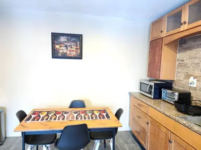 a kitchen with a table with chairs and a microwave at spacious and indulging in Meriden