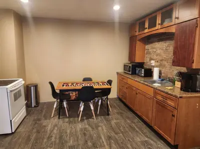 a kitchen with a table and some chairs in it at spacious and indulging in Meriden