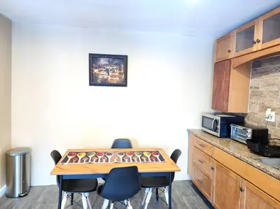 a kitchen with a table and chairs in a room at spacious and indulging in Meriden