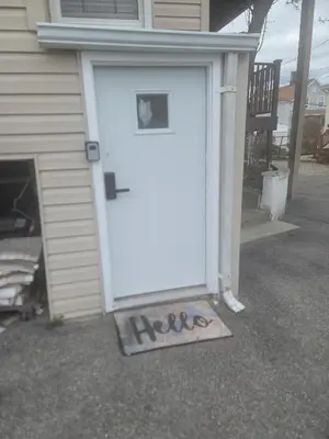 a white garage door with the word help written on it at The Subterranean Haven in Mount Vernon