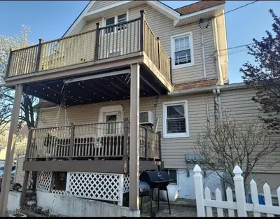 a house with a large deck on top of it at The Subterranean Haven in Mount Vernon