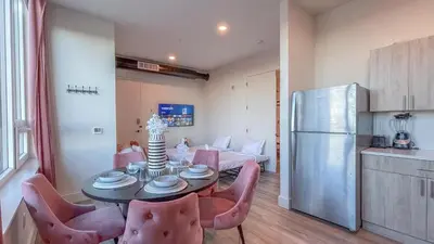 a kitchen and a dining room with a table and chairs at Rosy Retreat with NYC Views by the train, Free Parking, 3 beds, 20 Percent OFF 7 days in Newark