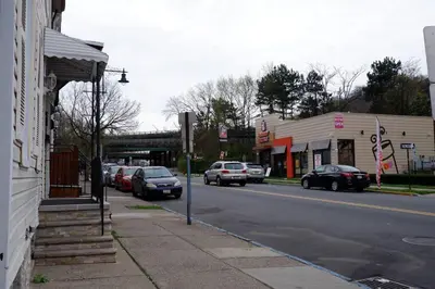 a street with cars parked on the side of the road at The Cozy Suite - 1BR with Free Parking in Paterson