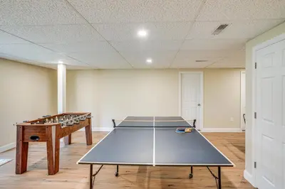a ping pong table in the middle of a room at Catskills Winter Getaway with Game Room in East Durham