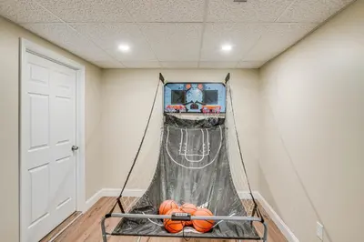 a room with a net with balls in it at Catskills Winter Getaway with Game Room in East Durham