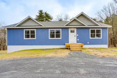 a blue house with a bench in front of it at Catskills Winter Getaway with Game Room in East Durham