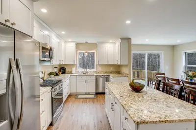 a kitchen with white cabinets and stainless steel appliances at Catskills Winter Getaway with Game Room in East Durham