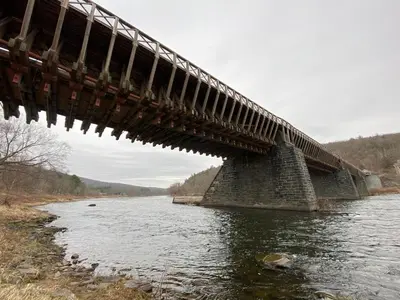 a bridge that is over a river at renovatedhot tubnear skiingtubingcozy & chic in Monticello
