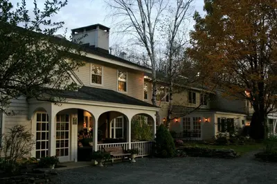 a white house with a chimney on top of it at Deerhill Inn in West Dover