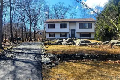 a large white house with a road in front of it at Poconos Retreat in Bushkill