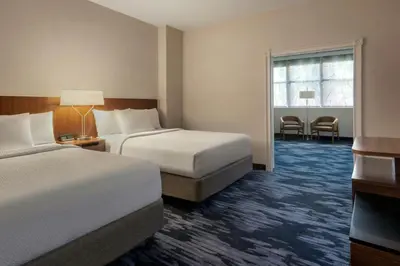 a hotel room with two beds and a window at Fairfield Inn & Suites by Marriott Albany Downtown in Albany