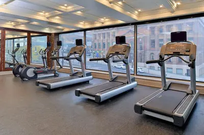 a gym with several tread machines in front of a window at Fairfield Inn & Suites by Marriott Albany Downtown in Albany