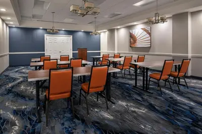 a dining room with tables and chairs in a room at Fairfield Inn & Suites by Marriott Albany Downtown in Albany