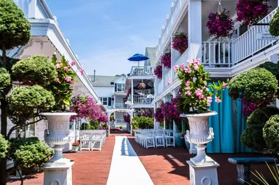 a courtyard with flowers and tables and chairs at Danfords Hotel & Marina in Port Jefferson Station
