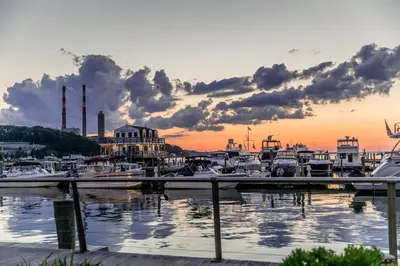 a group of boats docked in a marina at sunset at Danfords Hotel & Marina in Port Jefferson Station