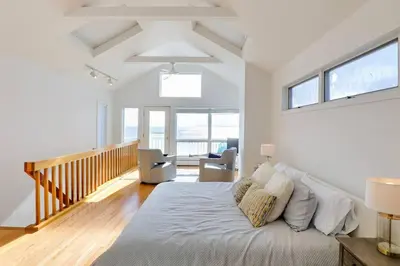 a bedroom with a large bed in a room at Cheerful 3 Bedroom Beach Front Cottage with Fire Place in Milford