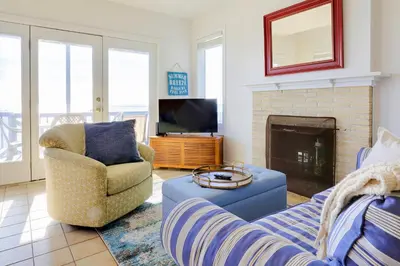 a living room with a couch and a fireplace at Cheerful 3 Bedroom Beach Front Cottage with Fire Place in Milford
