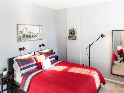 a bedroom with a red bed with a red blanket at Spacious Getaway by Wooster Square! in New Haven
