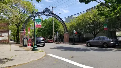 an arch on the side of a street with a car at Spacious Getaway by Wooster Square! in New Haven