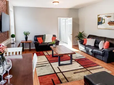 a living room with a couch and a table at Spacious Getaway by Wooster Square! in New Haven