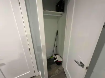 a small closet with a door and a mop at The Comfy Suite - 1BR with Free Parking in Paterson