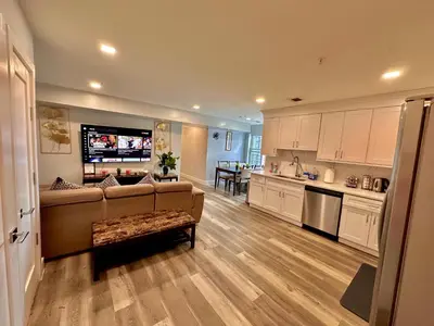a living room with a couch and a kitchen at The Classy Suite - 2BR with Free Parking in Paterson