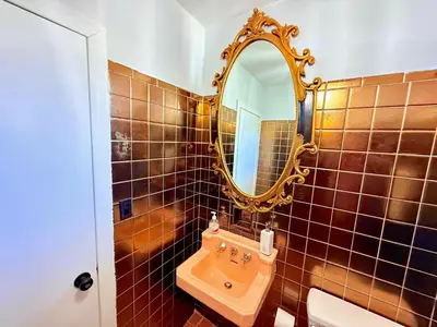 a bathroom with a sink and a mirror at Ultimate Luxury Villa - Pool, Sauna, Hot Tub & More in Paterson