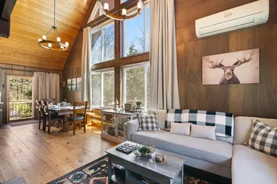 a living room with a couch and a table at Crooked Ear Cabin in Wilmington
