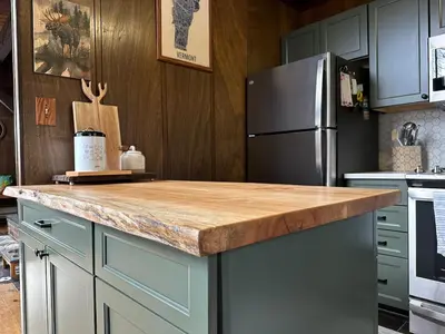 a kitchen with a wooden counter top and a refrigerator at Crooked Ear Cabin in Wilmington