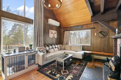 a living room with a couch and a table at Crooked Ear Cabin in Wilmington