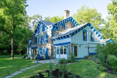 a blue house with a yard at Spacious 4bd Country Gem - Fire Pit & Chill Vibes in Highland