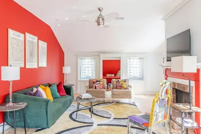 a living room with red walls and a green couch at Spacious 4bd Country Gem - Fire Pit & Chill Vibes in Highland