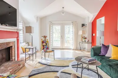 a living room with a green couch and a fireplace at Spacious 4bd Country Gem - Fire Pit & Chill Vibes in Highland