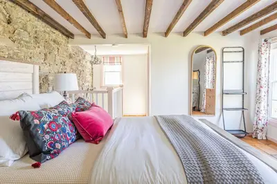 a bedroom with a bed with pillows on it at Spacious 4bd Country Gem - Fire Pit & Chill Vibes in Highland