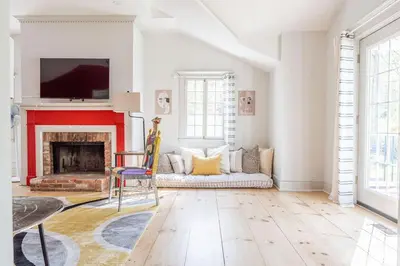 a living room with a fireplace and a tv at Spacious 4bd Country Gem - Fire Pit & Chill Vibes in Highland