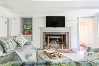 a living room with a fireplace and a tv at Spacious 4bd Country Gem - Fire Pit & Chill Vibes in Highland