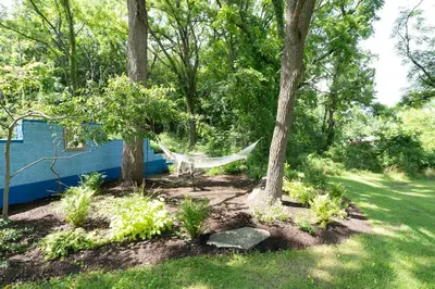 a hammock between two trees in a garden at Spacious 4bd Country Gem - Fire Pit & Chill Vibes in Highland