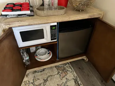 a microwave sitting on top of a wooden shelf at Country Cottage with beautiful views in Saugerties