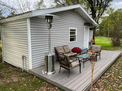 a wooden deck with two chairs and a table at Country Cottage with beautiful views in Saugerties
