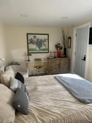 a bedroom with a large bed with two pillows on it at Country Cottage with beautiful views in Saugerties
