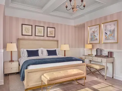 a bedroom with a large bed and a desk and a bed sidx sidx sidx sidx at The Northport Hotel in Northport