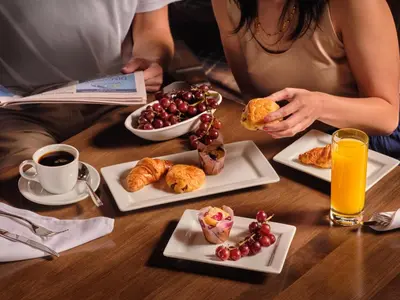 a woman sitting at a table with three plates of food at The Northport Hotel in Northport