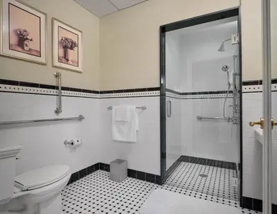 a bathroom with a shower and a toilet at The Northport Hotel in Northport
