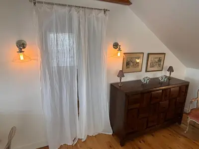 a living room with a white curtain and a dresser at Country House in Catskills in Saugerties